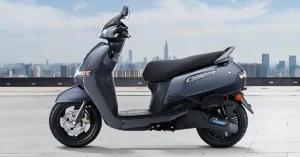 TVS iQube electric scooter left side view in matte blue finish parked on road