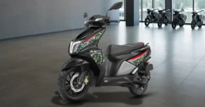 TVS NTORQ 125 Super Soldier Edition displayed inside a premium bike showroom with camouflage graphics