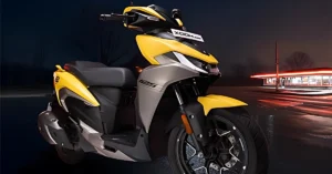 Hero Xoom 125 in yellow color parked near a neon-lit diner at night